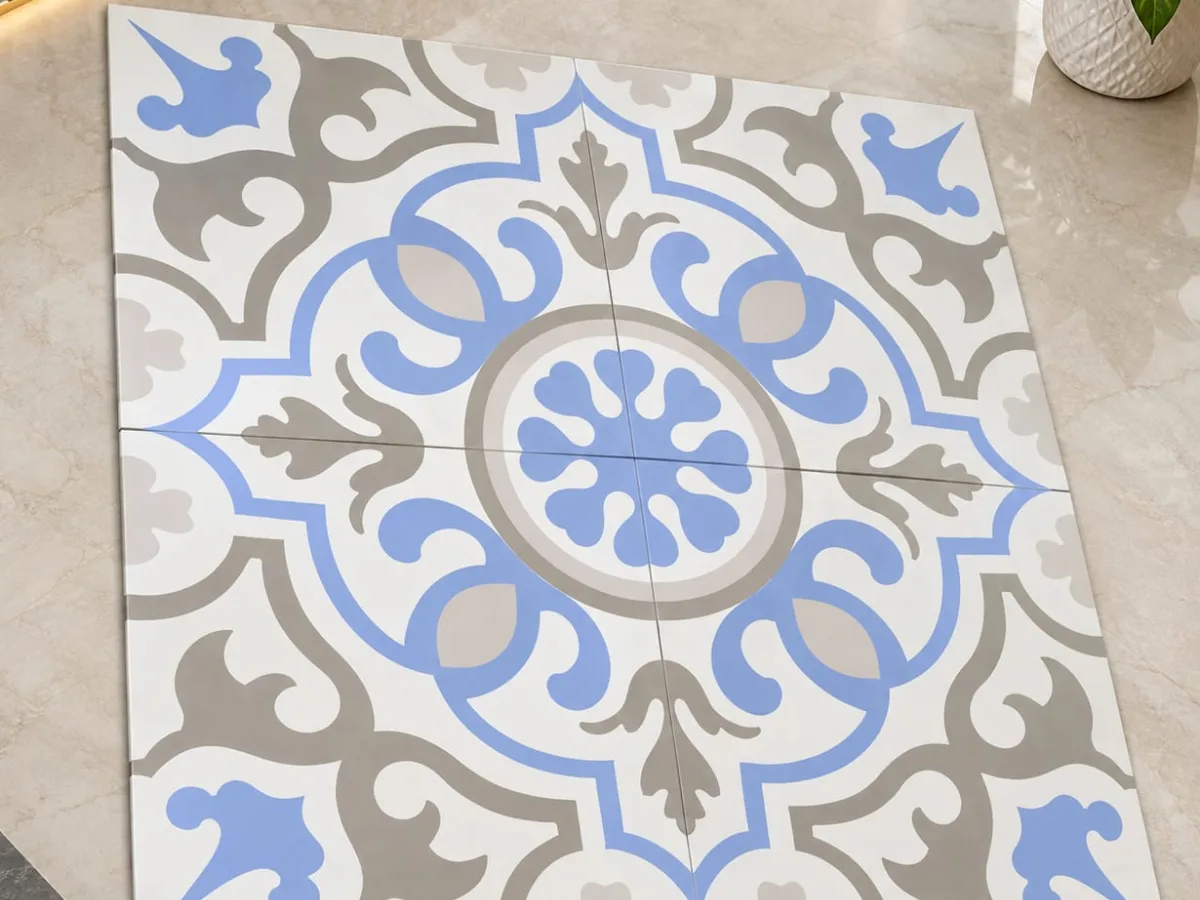 Four custom printed tiles forming one blue and grey medallion pattern on a marble floor